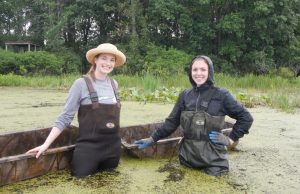 Julia Kostin and Rebecca Mann (2018 WNY PRISM Crew) take a break from their water chestnut search at the Audubon Community Nature Center. Photo Credit: WNY PRISM.
